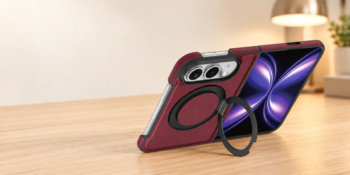 Burgundy PU leather folding phone case supported on a light desk by its open black ring stand.