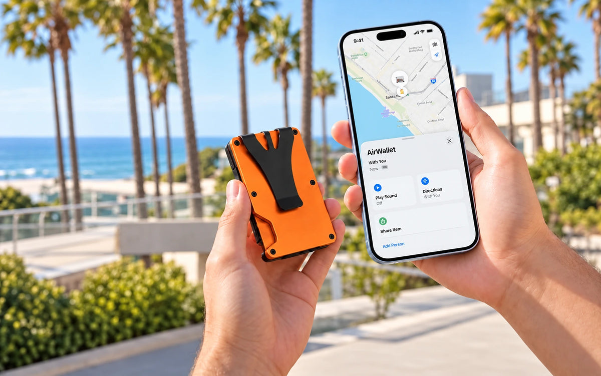 Hands holding an orange tracker wallet and a phone showing the wallet location by the coast.